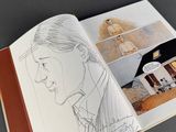 a book with a drawing of a man and a house