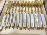a lot of silverware in a box on the table