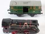 three toy trains sitting next to each other on a white surface