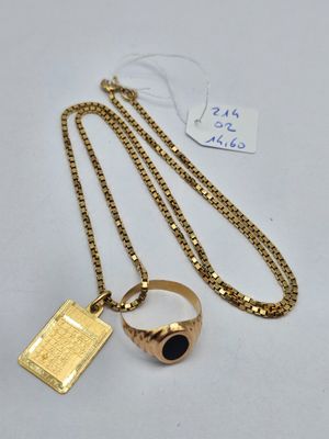 a gold plated ring with a black stone on a chain