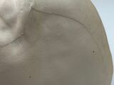 a white sculpture of an elephant on a white surface