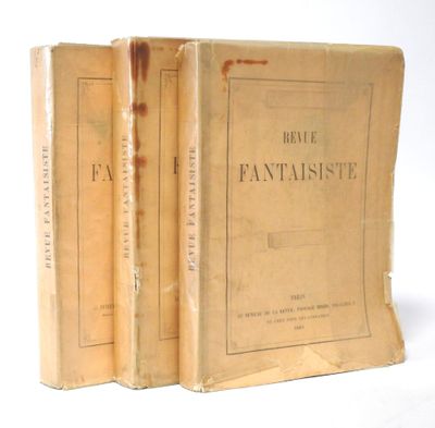 two old books sitting on top of each other on a white surface