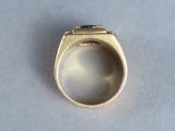an image of a gold ring on a white surface