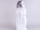 a white figurine of a woman with long hair