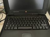 a laptop computer sitting on a desk with a keyboard