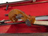 a violin that is sitting in a case on the floor