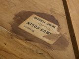 a label on a piece of wood on the floor