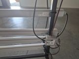 a metal rack with wires attached to it in a room