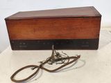 a small wooden box with a bunch of wires attached to it