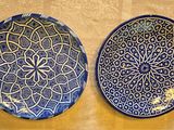 two plates that are sitting on the wall