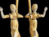 pair of carved wooden candlestick holders with angels on them