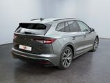 the rear end of a silver car in a white room