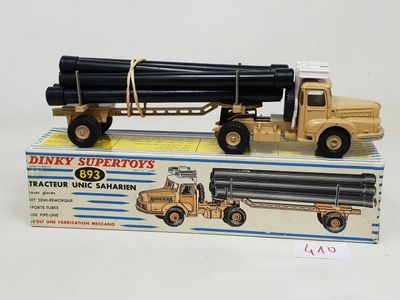 a toy truck with a large pipe on top of it