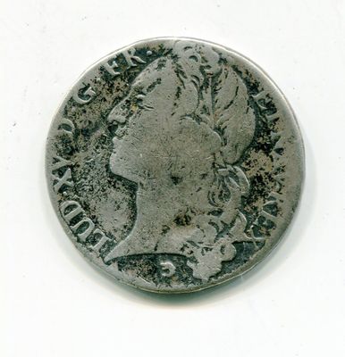 une vieille pièce de monnaie sur laquelle figure une tête de femme