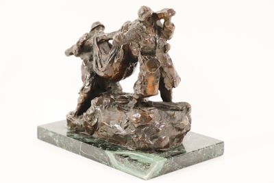 statue of a man and a woman on a rock with a dog