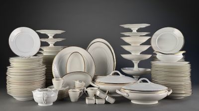 a lot of white plates and bowls on the table