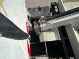 a close up view of a vehicle ' s front end with a trailer attached to it