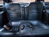 a black seat in the back of a car with a cell phone in it