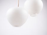 two white lamps hanging from a ceiling in a room