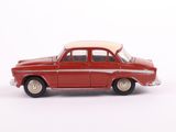 a red toy car that is sitting on a white surface