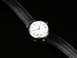 a close up of a wrist watch with roman numerals on it