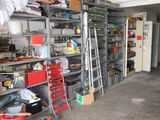 a garage with a lot of shelves and a ladder in it