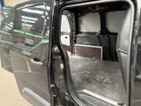 a black van with the door open and a bed in the back