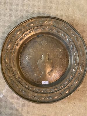 a silver plate on the table with a tag on it