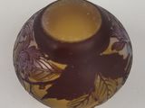 a small vase with a design on it on a table