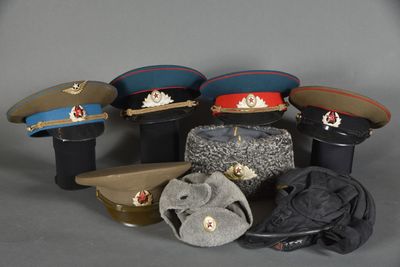 several hats and hats sitting on top of each other on a table