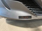 a close up of a car ' s grille with a sticker on it
