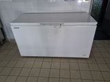 a white chest freezer in a kitchen with tile flooring