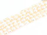 a close up of a row of white pearls on a white surface