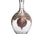 an image of a glass bottle with a gold and blue design