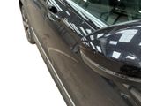 an image of a black car with a checkered side mirror
