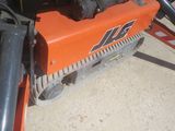 an orange machine that is sitting on the ground