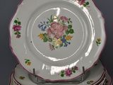 a stack of plates and a gravy dish on the table