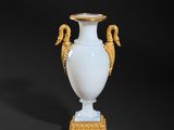 pair of white and gold vases with seahorses on a stand