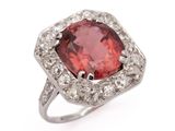 a close up of a red and white diamond ring on a white background