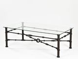 an iron and glass coffee table on a white background