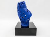 blue sculpture of a human head on a black base