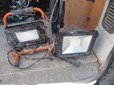 two televisions that are sitting in the back of a truck