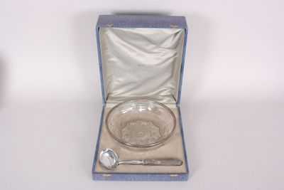 a glass bowl and spoon in a blue box