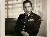 a black and white photo of a man in a military uniform