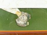 a rock with a knife stuck in it sitting on a table