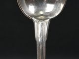 a silver spoon sitting on top of a black table