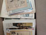 a cardboard box full of newspapers and other papers