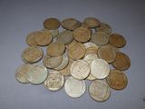 a pile of old coins sitting on a table