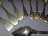 a lot of silver spoons and spoon spoons on a table