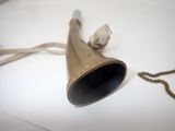 a bell that is on a table with a chain around it